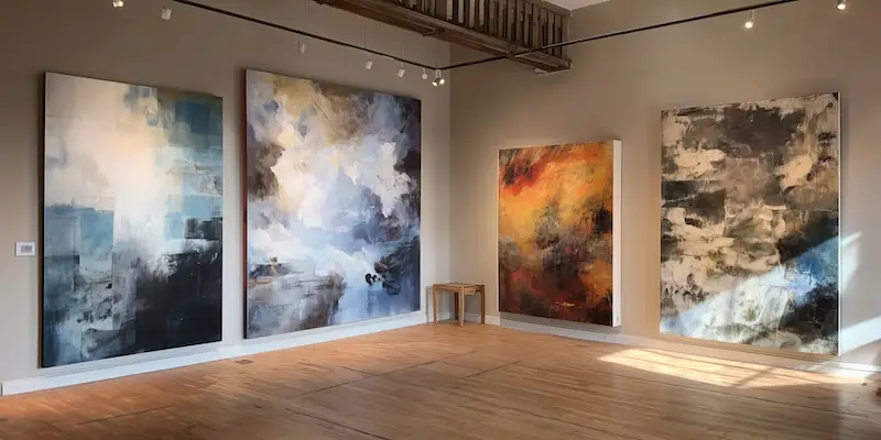gallery space showcasing large abstract canvas art on the walls